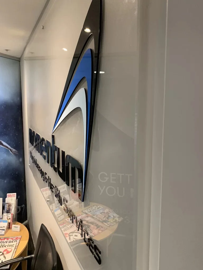 Dimensional blue-and-black logo on a wall