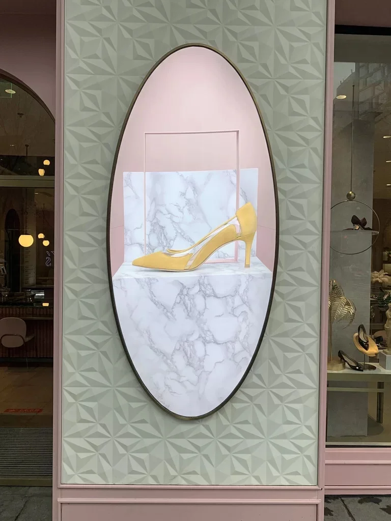 Oval illustrated display mounted on a patterned wall