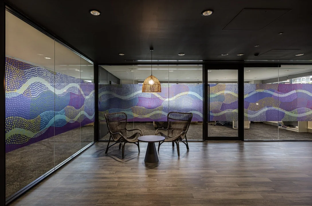 Colourful patterned privacy graphics across office glass